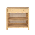 The Isla Nightstand Collection by Made Goods features a rectangular rattan nightstand with a soft-close drawer, two open shelves, and woven back panel, shown against a white background.