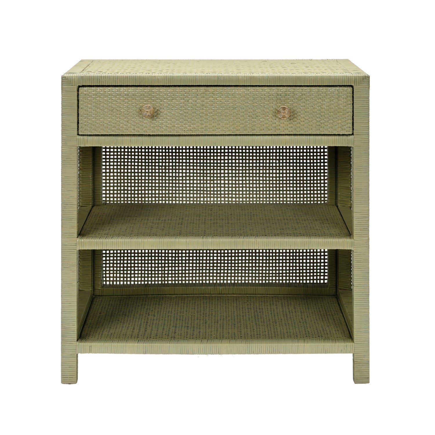 The Made Goods Isla Nightstand Collection features a rectangular light green nightstand with a rattan frame, one soft-close drawer, and two open shelves, shown against a white background.