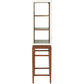 A Made Goods Jamison Cabinet with glass panels, two shelves, and elegant walnut legs stands on a tall wooden stool.