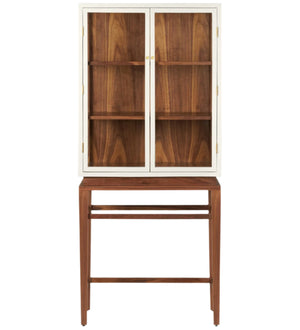 The Made Goods Jamison Cabinet features glass-paneled doors, three shelves, and stands on a matching wooden base with walnut legs and an open lower section.