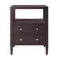 The Made Goods Jarin Nightstand Collection features a dark brown wood nightstand with two drawers on European glides, gold knobs, an open shelf, and tapered legs—showcasing quality craftsmanship.