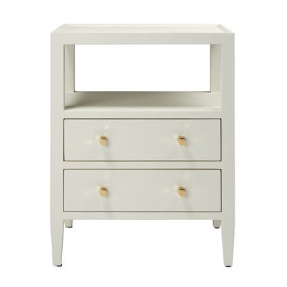 The Jarin Nightstand Collection by Made Goods features a white linen finish, two drawers with gold round knobs, European glides, an open shelf above the drawers, and tapered legs—all designed with quality craftsmanship.