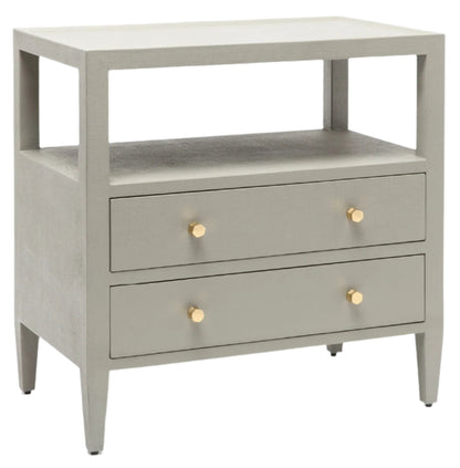 The Made Goods Jarin Nightstand is a light gray linen piece with two drawers featuring round gold knobs, European glides for smooth use, and an open shelf above the drawers.