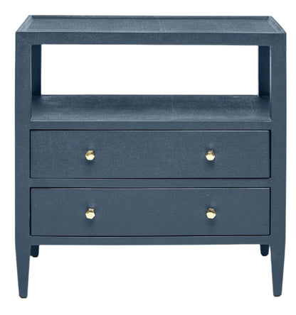The Jarin Nightstand by Made Goods is a dark blue wooden piece with two European-glide drawers, gold knobs, and an open shelf above, highlighting quality craftsmanship.