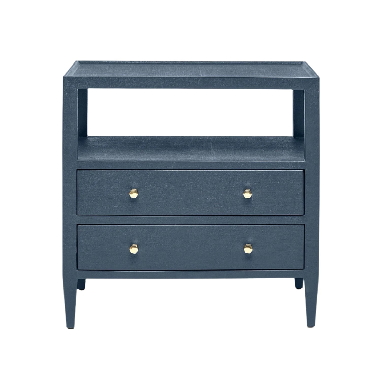 The Jarin Nightstand Collection by Made Goods features a dark blue wooden nightstand with two drawers, European glides, brass knobs, an open shelf, and four tapered legs. Shown against a white background.