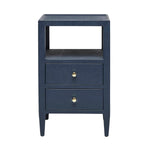 The Made Goods Jarin Nightstand Collection features a navy blue nightstand with two drawers on European glides, gold knobs, an open shelf, and tapered legs, shown against a white background.