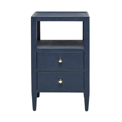The Made Goods Jarin Nightstand Collection features a navy blue nightstand with two drawers on European glides, gold knobs, an open shelf, and tapered legs, shown against a white background.