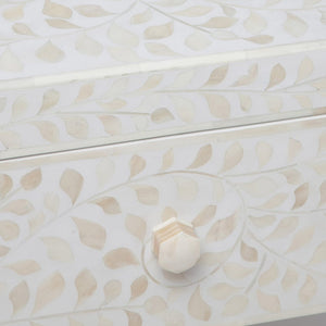 Close-up of a white Made Goods Lexi Dresser drawer, showcasing a decorative Indian pattern inlaid with camel bone and finished with a hexagonal knob.