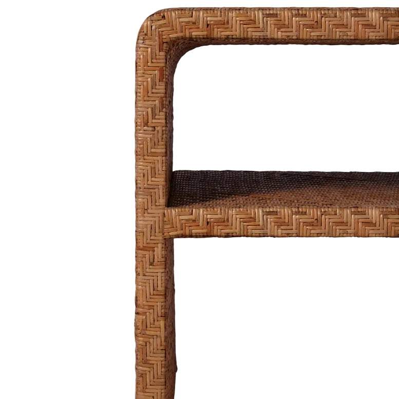 Close-up of the Lynette Side Table in Dark Rattan by Made Goods, highlighting its corner, two shelves, and textured woven facade against a plain white background.