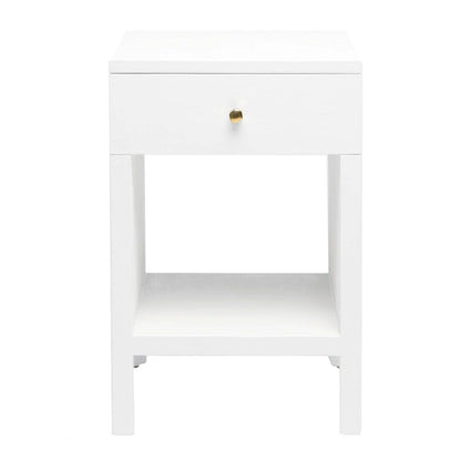 The Maris Nightstand Collection by Made Goods features a white wooden nightstand with raised feet, one drawer with a round knob and overlay panels, plus an open lower shelf, shown against a plain white background.
