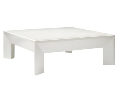 The Roberts Coffee Table by Made Goods is a modern square white table with a flat top and thick, uniquely shaped legs, showcased against a plain white background.