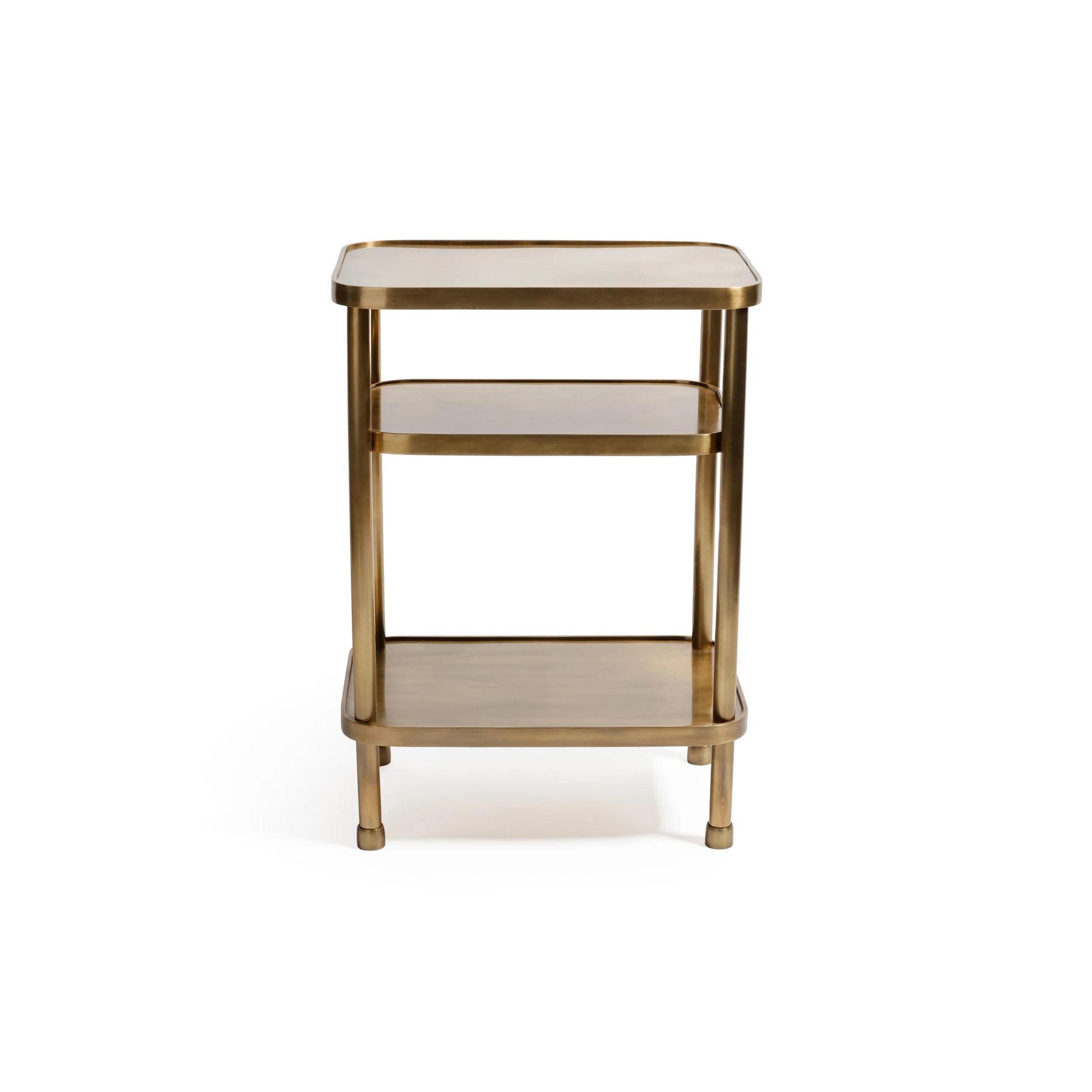 The Aman Etagere by Zodax is a small, rectangular gold metal side table with three tiers and rounded edges. Its minimalist design stands out elegantly against a plain white background.