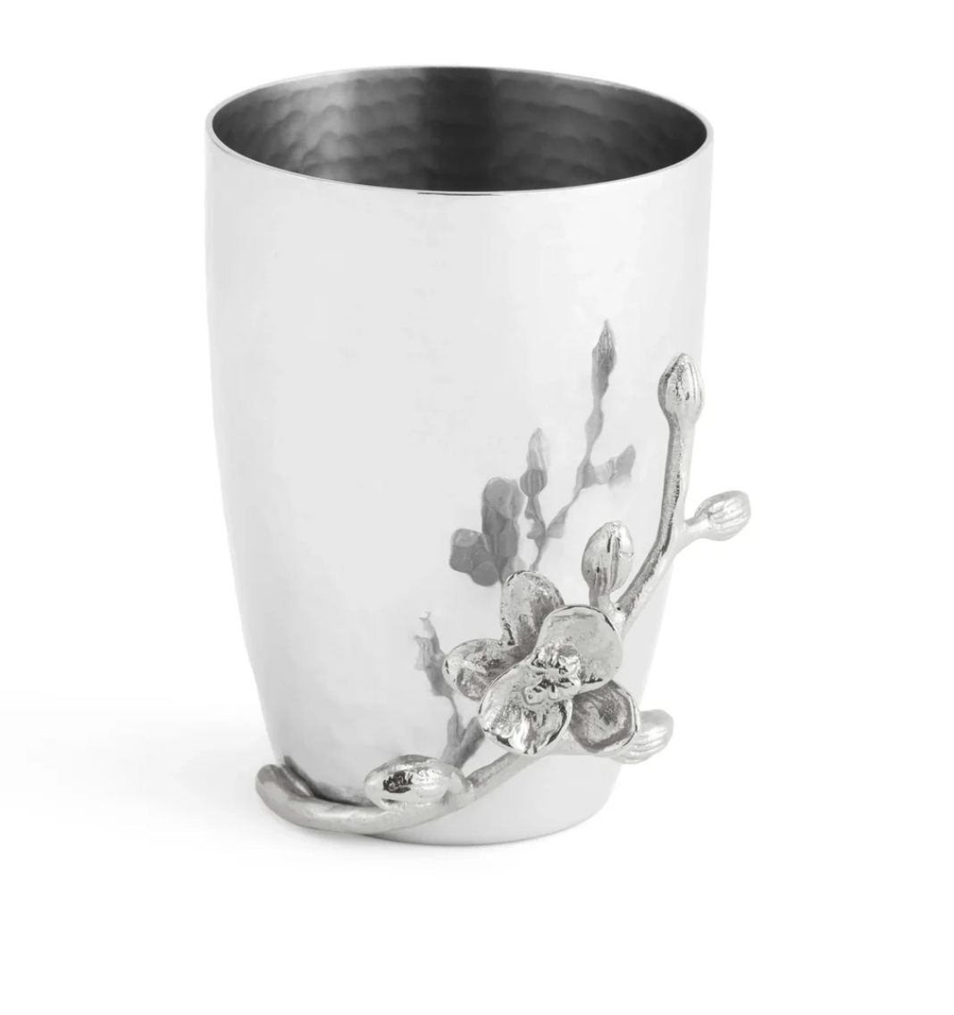 Silver cup with a hammered texture, featuring an embossed branch and flower motif on the side—an elegant addition from the Michael Aram White Orchid Bath Collection that pairs beautifully with other orchid bathroom accessories or the White Orchid Soap Dispenser for a touch of refined luxury.