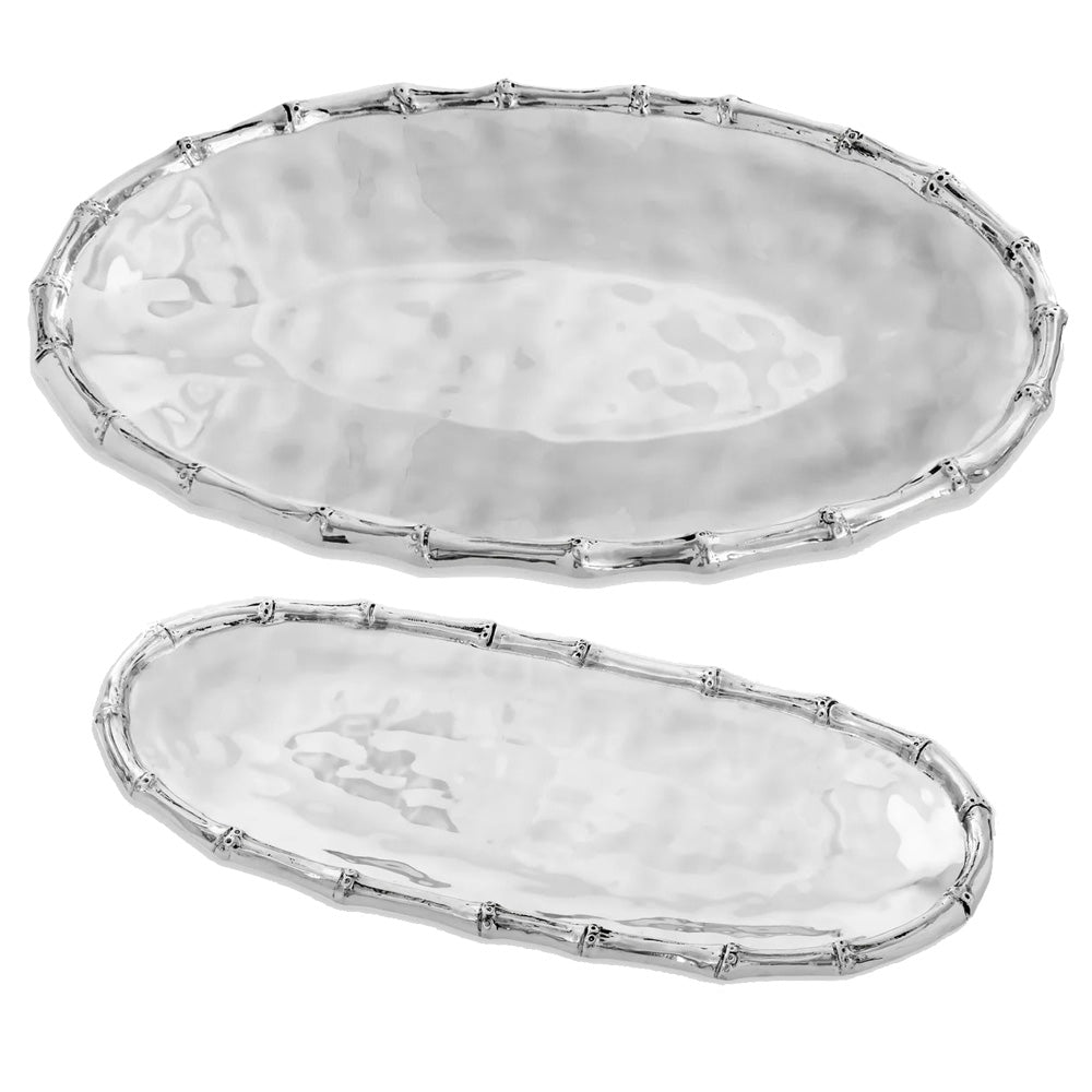Two trays from the Garden Bamboo Oval Tray Collection by Beatriz Ball, featuring a hammered texture and bamboo-inspired edges, are displayed on a white background.