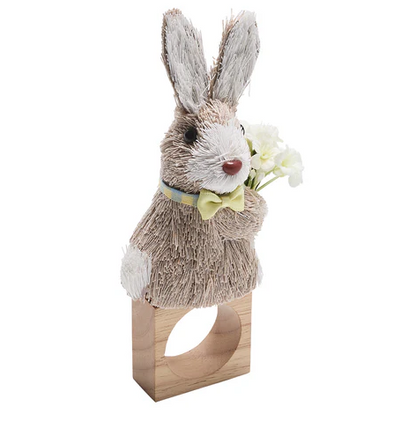 Add a festive touch to your table with the Kim Seybert Easter Bunny Napkin Ring, featuring a straw-style bunny with a yellow bow tie and white flowers on a wooden ring—perfect for springtime decor.
