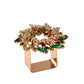 The Kim Seybert Gem Wreath Napkin Ring Set features gold square rings adorned with multicolored gemstones in a circular, floral pattern—ideal for adding festive sparkle to your holiday table setting.