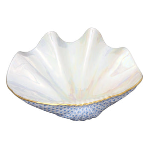 The Reserve Collection Giant Clam by Herend is a white porcelain bowl shaped like a clam shell, with a glossy finish, blue textured base, and gold trim—evoking the elegance of Chinese ceramics admired by Marco Polo.