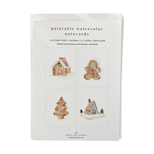 Emily Lex Studio Watercolor Paintable Notecards Set containing eight blank cards featuring illustrations of a gingerbread house, a gingerbread man, a Christmas tree, and a small cottage.