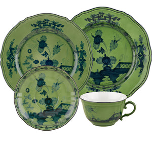 A four-piece green ceramic set from the Oriente Italiano Malachite Dinnerware Collection by Ginori 1735, featuring blue floral patterns and including two plates, one bowl, and one teacup.