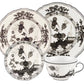 Four-piece Oriente Italiano Albus Dinnerware Collection by Ginori 1735 includes two plates, a saucer, and a teacup in black and white floral porcelain.