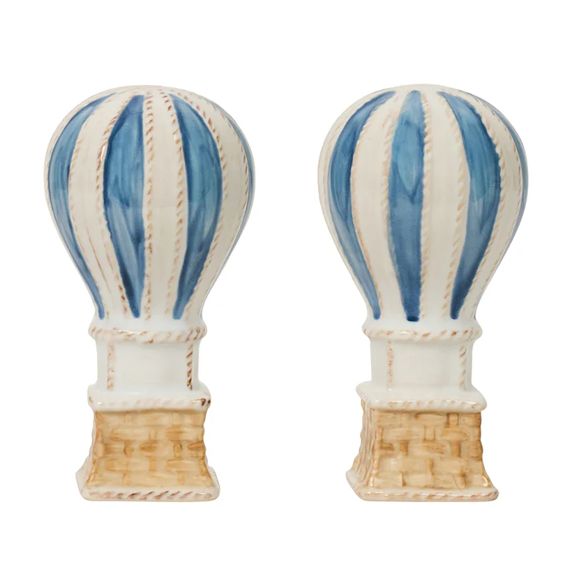 The Juliska L'Amour Toujours Hot Air Balloon Salt and Pepper Shaker Set features two hand-painted, blue and white striped balloon shakers with basket bases—an enchanting table accent or delightful gift, presented in a signature Juliska gift box.
