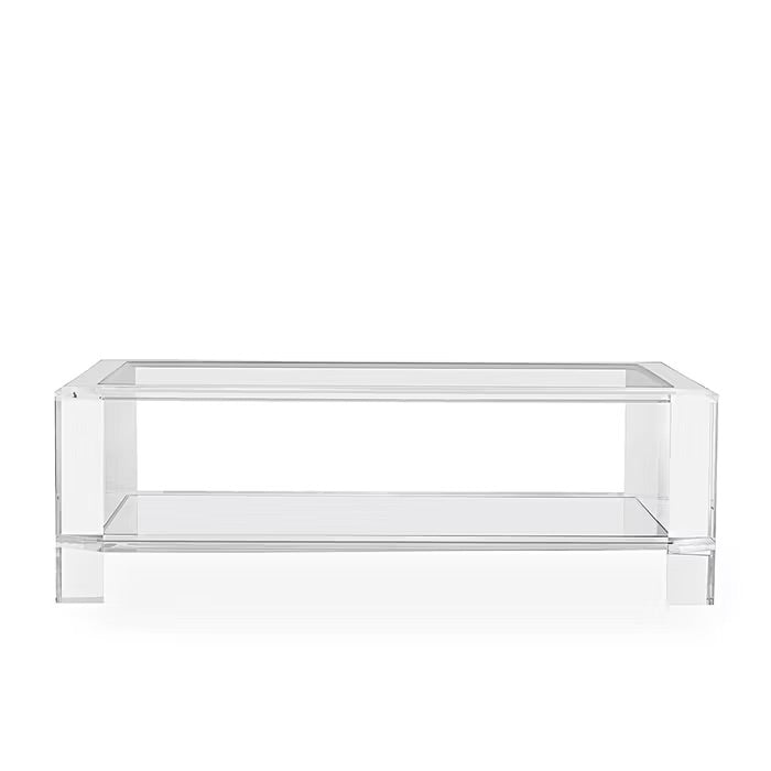 The Surrey Acrylic Rectangular Cocktail Table by Interlude Home features a clear design with a lower shelf, ideal for contemporary living rooms. Shown on a white background.