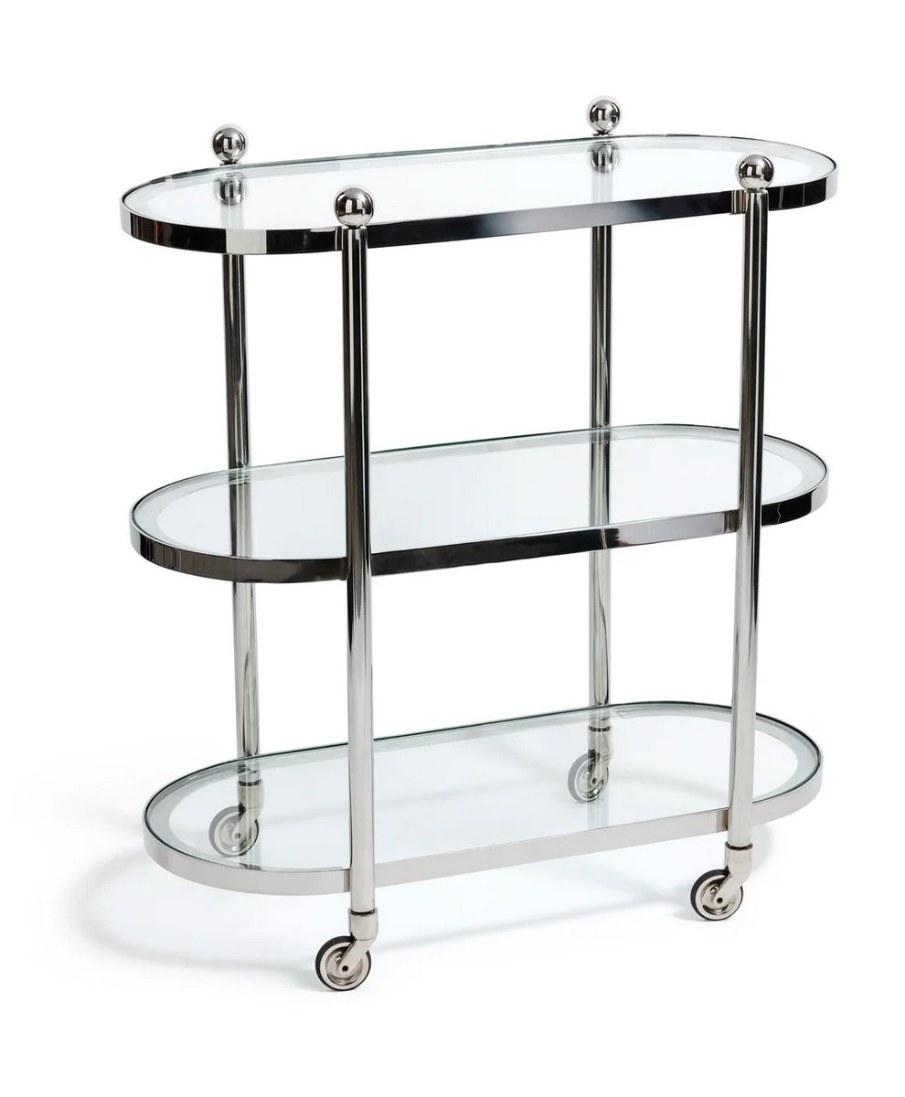 The Zodax Oval Round Bar Cart Trolley features three glass and chrome shelves, four caster wheels, and spacious storage for bar accessories, shown against a white background.