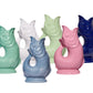 Six Fish Gluggle Jugs from The Original Gluggle Jug's Collection are arranged in two rows against a white background, displaying green, white, light green, blue, pink, and dark blue shades. Each handmade jug is a true British design icon.