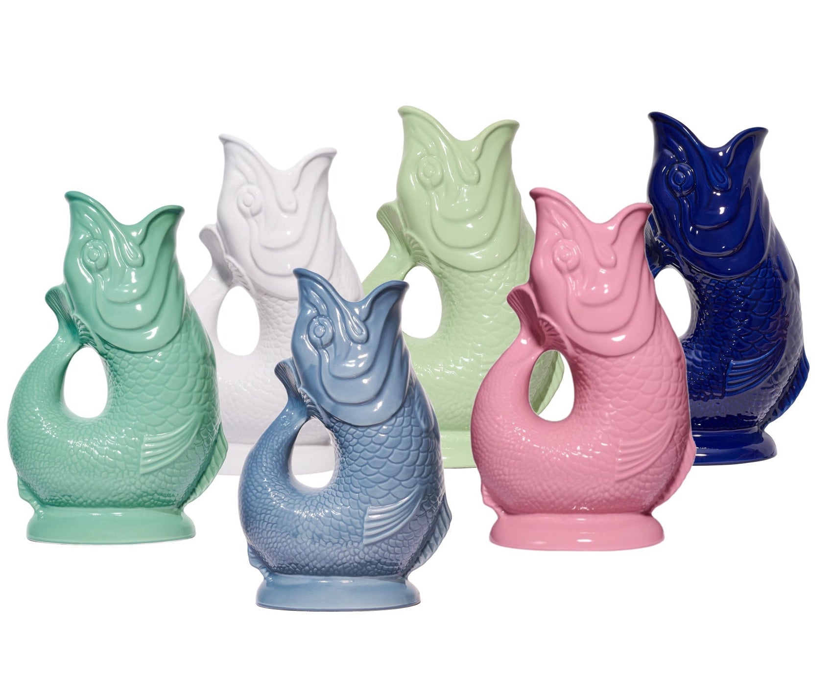 Six Fish Gluggle Jugs from The Original Gluggle Jug's Collection are arranged in two rows against a white background, displaying green, white, light green, blue, pink, and dark blue shades. Each handmade jug is a true British design icon.
