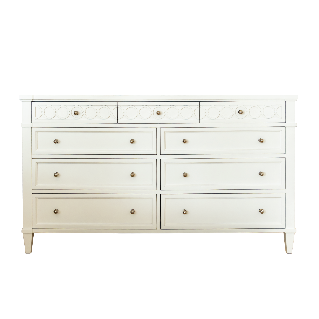 The Morten Dresser by Hickory Chair features a classic white wooden design with nine drawers, round metal knobs, and decorative circular patterns on the top row.