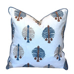 Introducing the Gobi Blue Down Pillow by Hive Custom Pillows—a 22x22 white square throw pillow adorned with blue, brown, and beige tree-inspired embroidered patterns and finished with elegant blue piping along the edges. Expertly handmade, this pillow can be custom crafted with a luxurious down fill for enhanced comfort and style.