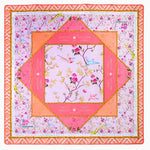 The Mahjong Mat Collection by Oh My Mahjong is a square, multi-layered mat with floral and geometric patterns in pink, orange, and gold, featuring measurement markings on the edges and a non-slip surface for stability.