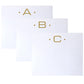 Three Gold Initial Large Notepads from Black Ink, each featuring a distinct letter (A, B, or C) and elegant dot accents, are artfully overlapped on a white background to highlight their superior quality and velvety smooth finish.