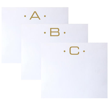 Three Gold Initial Large Notepads from Black Ink, each featuring a distinct letter (A, B, or C) and elegant dot accents, are artfully overlapped on a white background to highlight their superior quality and velvety smooth finish.