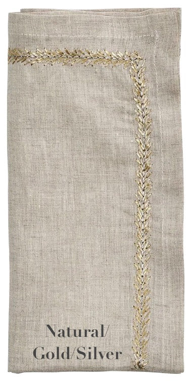 The Kim Seybert Jardin Napkin Set features folded beige linen napkins with elegant gold and silver embroidered borders and "Natural/Gold/Silver" text.