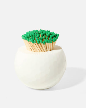 The Golf Match Striker Collection by Tart by Taylor offers a stylish accessory shaped like a white golf ball, perfect for holding and igniting matchsticks with flair.