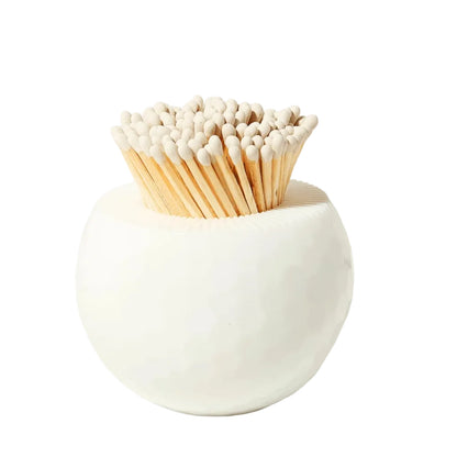 A spherical white Tart by Taylor Golf Match Striker filled with wooden matches.