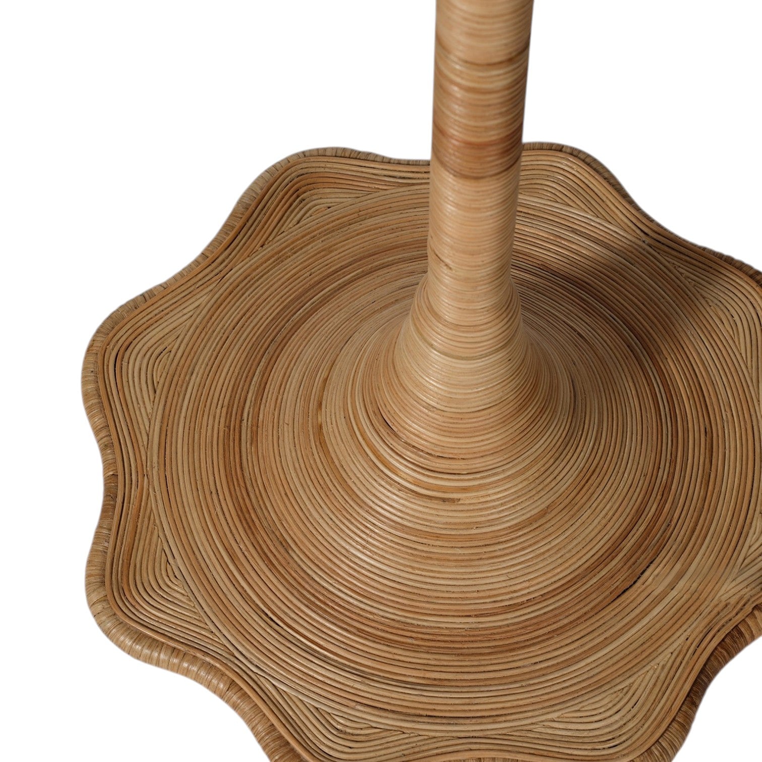 Close-up of the Solana Floor Lamp by Made Goods, featuring a woven rattan stand with a circular base and wavy edges that highlight coiled, textured patterns in natural wood tones—an artistic piece inspired by organic forms.