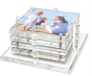 The Tara Wilson Designs Photo Drink Coaster Set features clear coasters displaying your favorite photo of a woman and child at the beach, neatly stacked in a matching acrylic holder to showcase cherished memories.