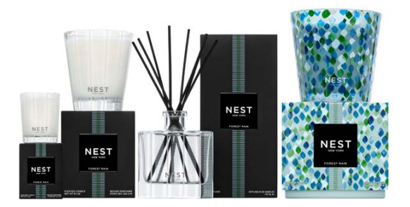 The Nest Forest Rain Scent Collection features a scented candle, reed diffuser, and decorative candle in black and patterned green-blue packaging, evoking an aquatic veil of fig leaves.