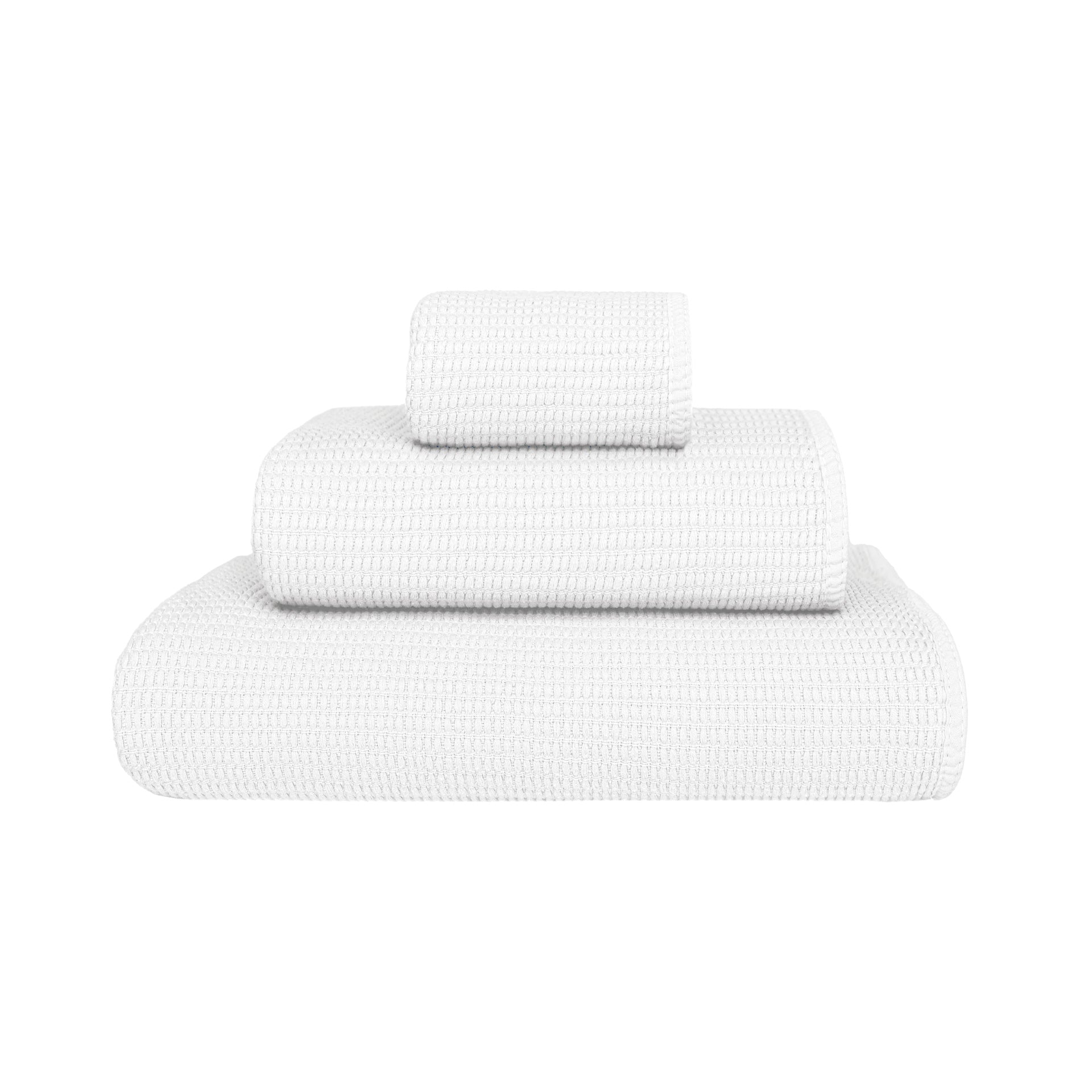 Three white towels of varying sizes from the Puro White Bath Collection by GRACCIOZA, featuring Zero Twist technology for natural comfort and high absorbency, neatly stacked against a plain white background.