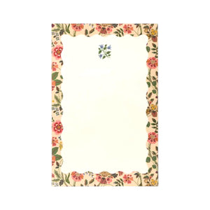 The Gracie Notepad by Rifle Paper Co. features a rectangular design with a scalloped floral border and a small blue flower motif at the top center on a clean white background, making it perfect as an illustrated notepad or a charming to-do list.