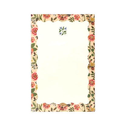 The Gracie Notepad by Rifle Paper Co. features a rectangular design with a scalloped floral border and a small blue flower motif at the top center on a clean white background, making it perfect as an illustrated notepad or a charming to-do list.
