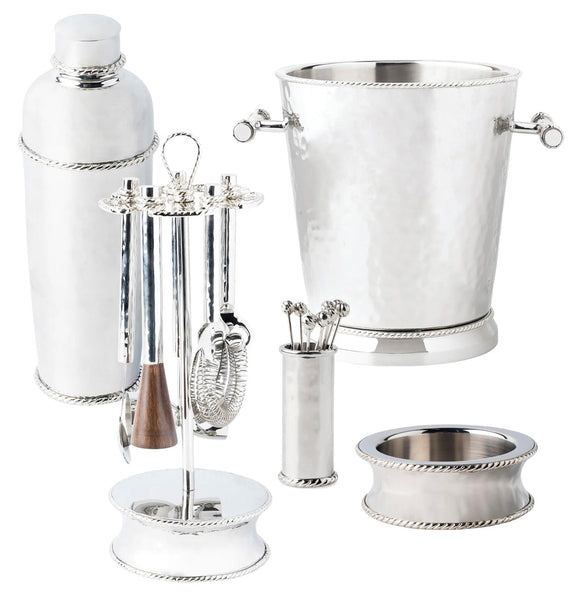 The Juliska Graham Barware Collection by Juliska is a set of silver bar tools featuring modern silhouettes and a gleaming mirror polish, which includes a champagne bucket, shaker, utensil holder with various utensils, toothpick holder, and coasters.