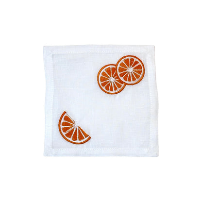 White linen napkin with embroidered orange slices—three whole in one corner, a wedge in the other—pairs perfectly with Haute Home's Grapefruit Coaster Set for a fresh, coordinated table.