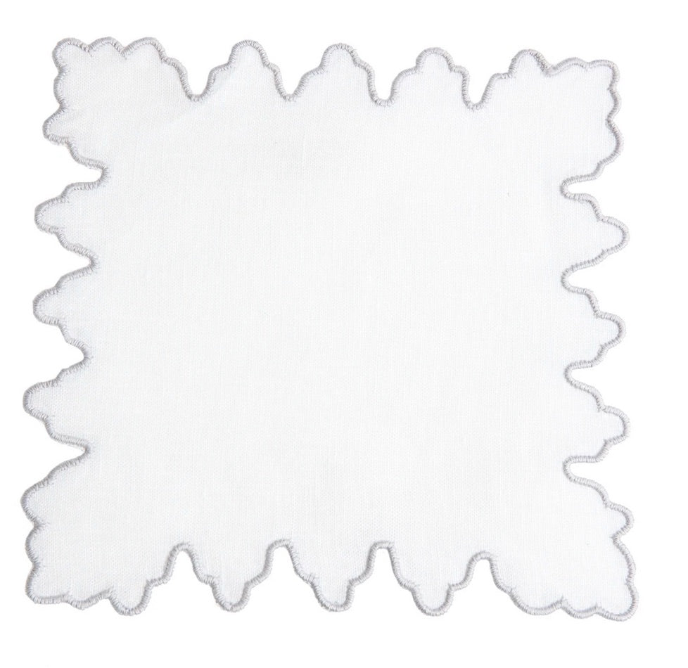 White cloth napkin with a scalloped edge and light grey trim, displayed flat—ideal to pair with the Haute Home Sultan Coaster Set for an elegant home gift.