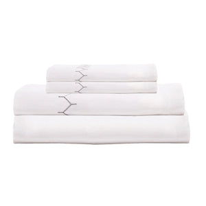 The Stitched Gray Sheet Set by John Robshaw, crafted from organic cotton with subtle hand embroidery, is neatly folded and displayed on a plain white background.