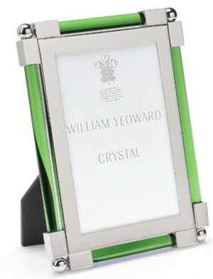 The Moss Green Classic Frame Collection by William Yeoward Crystal features a rectangular photo frame with green glass sides, bright silver metal corners, and a black easel support.