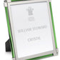 The Moss Green Classic Frame Collection by William Yeoward Crystal features a silver and green photo frame with a bright finish and a branded placeholder insert.