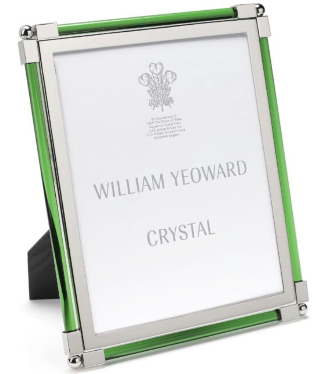 The Moss Green Classic Frame Collection by William Yeoward Crystal features a silver and green photo frame with a bright finish and a branded placeholder insert.